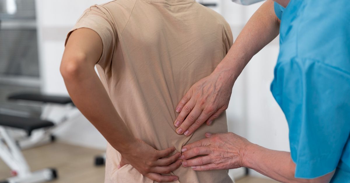 Office worker sitting long hours showing desk job lifestyle increasing spine stress and lower back discomfort