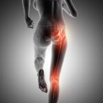 Person experiencing tingling from lower back to legs due to nerve compression and seeking medical evaluation