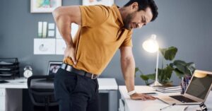 Person ignoring back pain leading to serious spine issues and consulting a spine specialist for evaluation